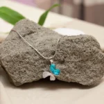 Hanging view of Butterfly Dream Pendant Necklace – 925 Silver with Teal Heart-Cut Gemstones