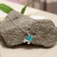 Hanging view of Butterfly Dream Pendant Necklace – 925 Silver with Teal Heart-Cut Gemstones