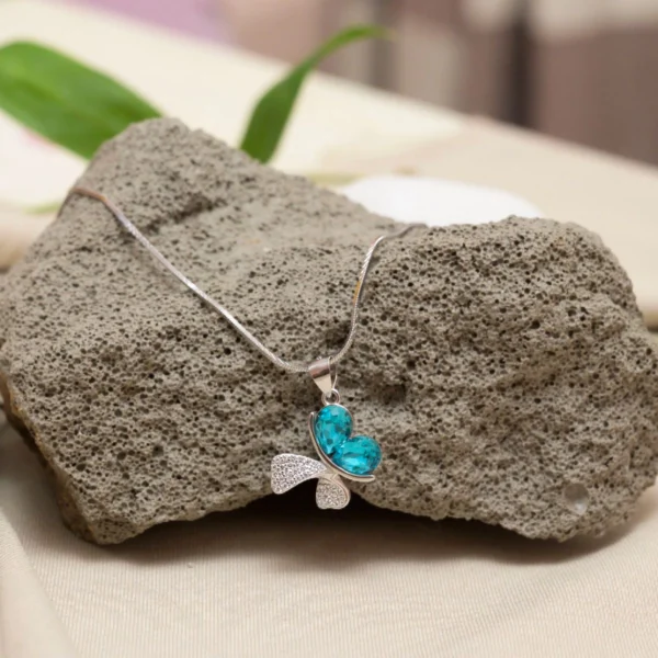 Hanging view of Butterfly Dream Pendant Necklace – 925 Silver with Teal Heart-Cut Gemstones