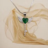 Top view of Green Heart Winged Key Pendant Necklace