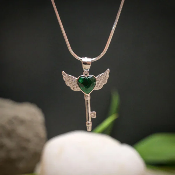 Hanging view of Green Heart Winged Key Pendant Necklace