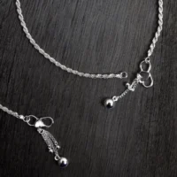 Close up of Rope Chain Anklets – Classic Twisted 925 Silver Design with Dangling Charms