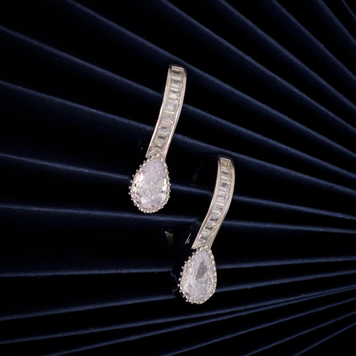 Huggie Hoops with Pear Drop Earrings – 925 Silver 1 Close up of Huggie Hoops with Pear Drop Earrings 925 Silver