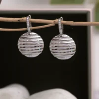 Close up of Ripple Disc Drop Earrings 925 Silver