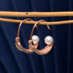 Close up of Rose Gold Feather Pearl Open Hoops 925 Silver