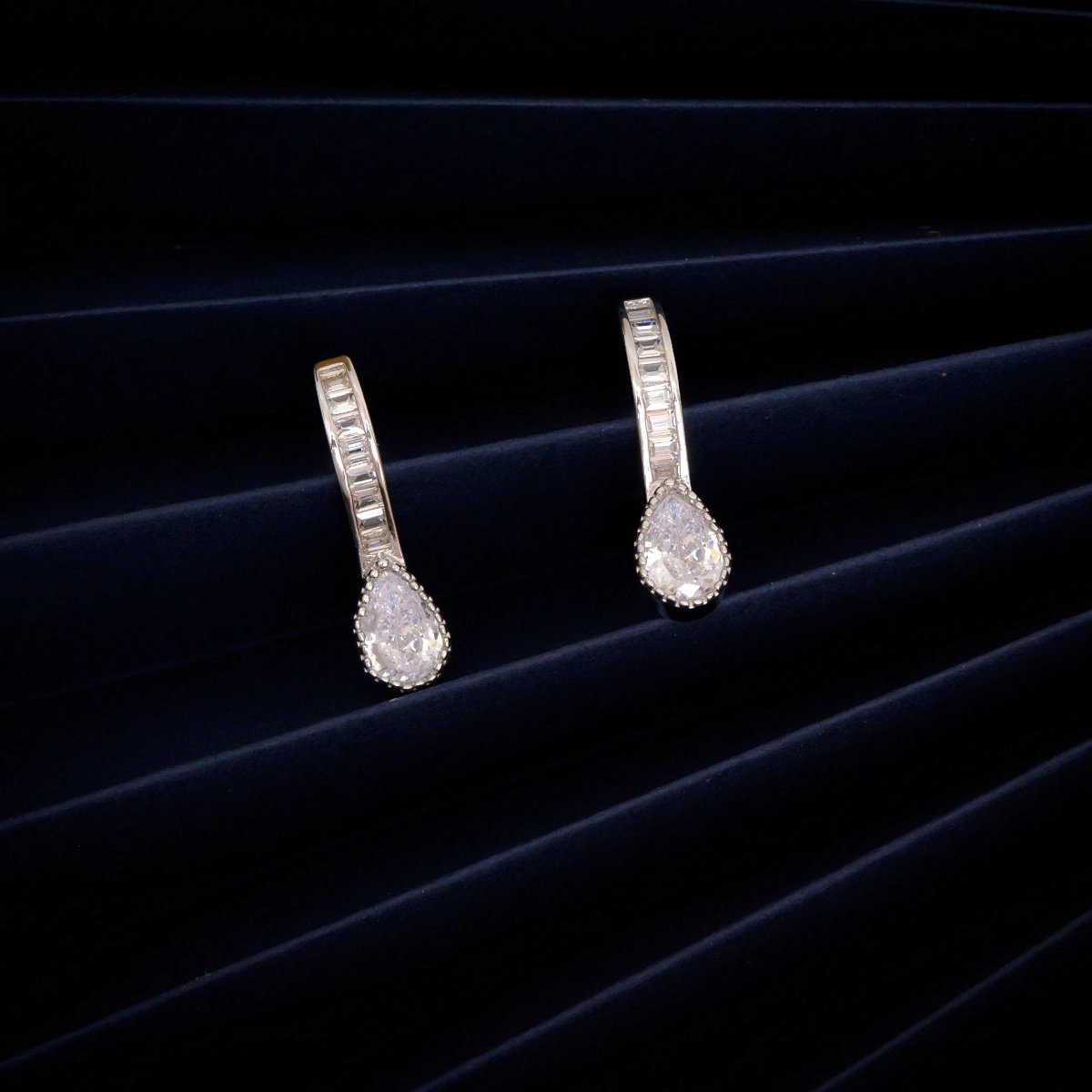 Huggie Hoops with Pear Drop Earrings – 925 Silver 2 Display of Huggie Hoops with Pear Drop Earrings 925 Silver