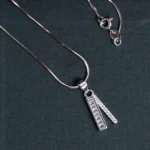 Pendant and chain lock close up of Baguette Bar Pendant and Huggie Set 925 Silver