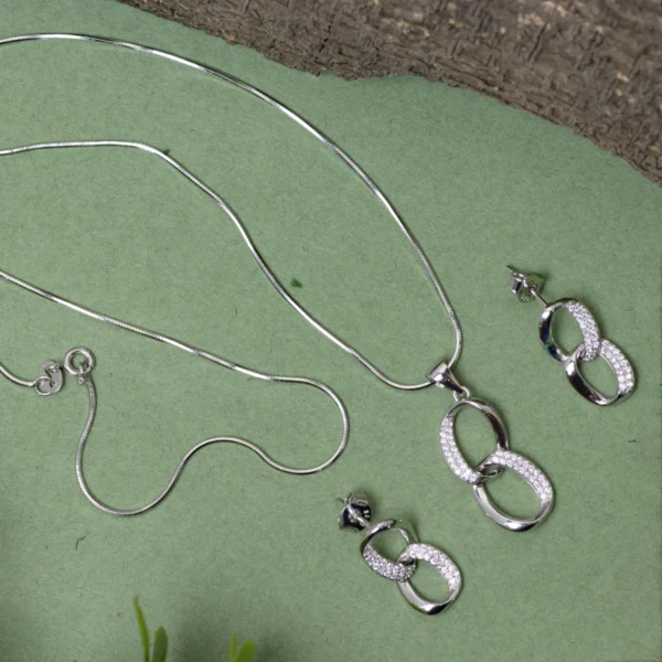Pendant, snake chain and earrings display of Interlocking Ovals Pave Set 925 Silver