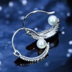 Close up of Bohemian Feather Pearl Huggie Hoop Earrings 925 Silver