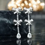Close up of Dainty Bow and Pear Drop CZ Earrings 925 Silver