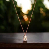Close up of Elegant MOP CZ Good Luck Gourd Necklace Rose Gold Polish 925 Silver