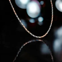 Close up of Intricate Dual-Tone Woven Chain Rose Gold and Silver Finish