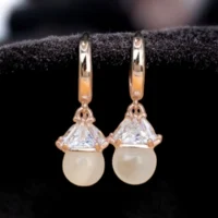 Close up of Rose Gold Minimalist Pearl Huggie Hoop Earrings 925 Silver