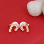 Close up of Rose Gold White Enamel Huggie Hoop Earrings 925 Silver