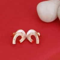 Close up of Rose Gold White Enamel Huggie Hoop Earrings 925 Silver
