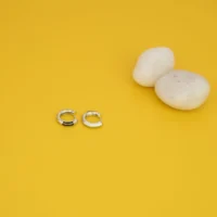 Front view of the Asymmetrical Black Enamel Huggie Hoop Earrings 925 Silver