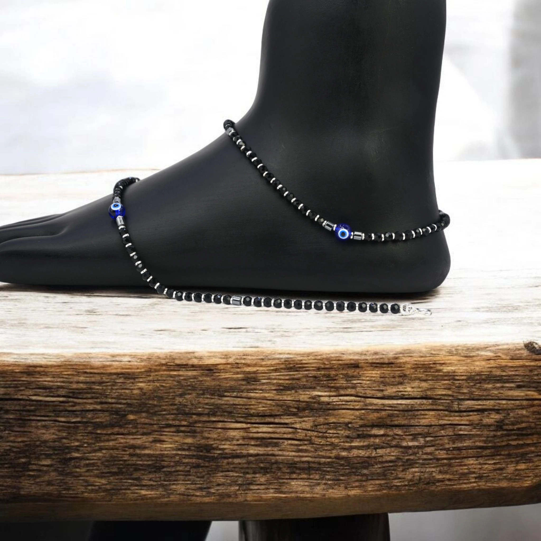 Minimalist Black Bead Evil Eye Anklets – 925 Silver 2 Mannequin leg with anklets on display of Minimalist Black Bead Evil Eye Anklets 925 Silver